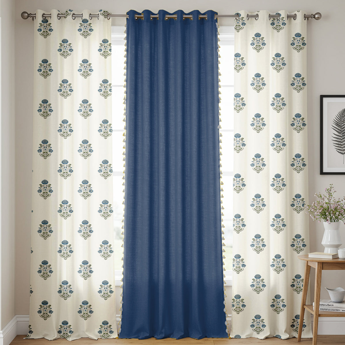 Set of three cotton curtains with two cream panels featuring blue floral prints and a solid navy blue center panel.