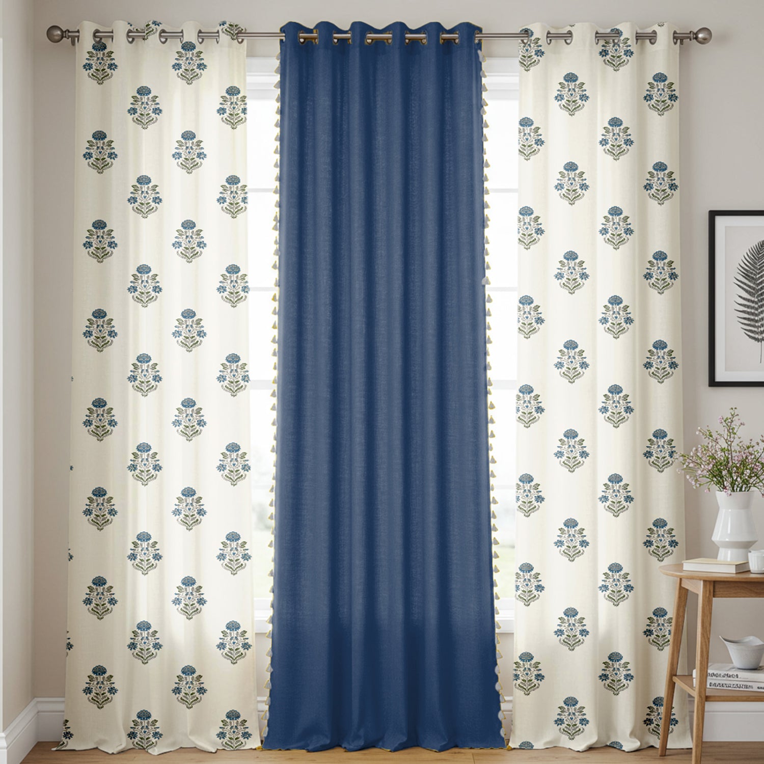 Set of three cotton curtains with two cream panels featuring blue floral prints and a solid navy blue center panel.